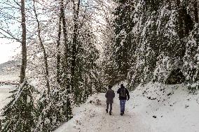 People Hiking Around The Bavarian Alpine Lake Eibsee In Winter