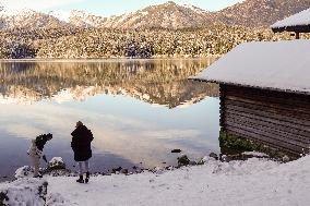 People Hiking Around The Bavarian Alpine Lake Eibsee In Winter