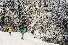 People Hiking Around The Bavarian Alpine Lake Eibsee In Winter