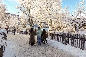 People Hiking Around The Bavarian Alpine Lake Eibsee In Winter