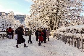 People Hiking Around The Bavarian Alpine Lake Eibsee In Winter