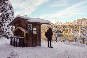 People Hiking Around The Bavarian Alpine Lake Eibsee In Winter