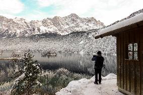 People Hiking Around The Bavarian Alpine Lake Eibsee In Winter