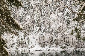 People Hiking Around The Bavarian Alpine Lake Eibsee In Winter