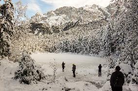 People Hiking Around The Bavarian Alpine Lake Eibsee In Winter