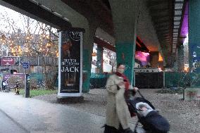 Woman With Baby Stroller Under A Munich Bridge