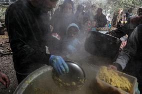 Palestinians Receive Food Amid Food Crisis - Gaza