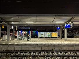 Passengers Waiting During Sleet At A Train Station On Munich