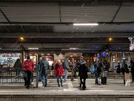 Passengers Waiting During Sleet At A Train Station On Munich