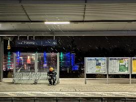 Passengers Waiting During Sleet At A Train Station On Munich