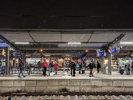 Passengers Waiting During Sleet At A Train Station On Munich