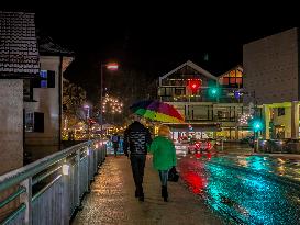 Couple Walking With A Large Umbrella On A Rainy Evening