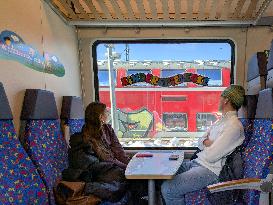 Passengers Seated In The Kinder Spielecke On A Regional Train