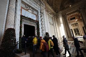 Pilgrims pass through the Holy Door