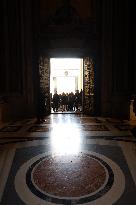 Pilgrims pass through the Holy Door