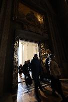 Pilgrims pass through the Holy Door