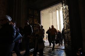 Pilgrims pass through the Holy Door