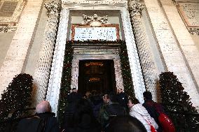 Pilgrims pass through the Holy Door