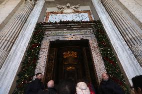 Pilgrims pass through the Holy Door