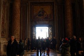 Pilgrims pass through the Holy Door