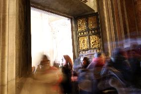 Pilgrims pass through the Holy Door