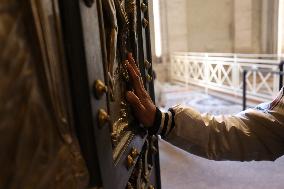 Pilgrims pass through the Holy Door