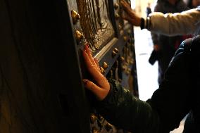 Pilgrims pass through the Holy Door