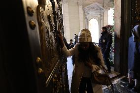 Pilgrims pass through the Holy Door