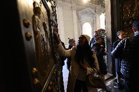 Pilgrims pass through the Holy Door