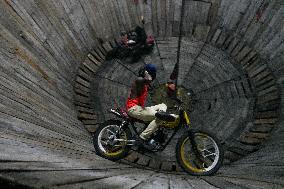 Two Circus Men Perform On The Wall Of Death