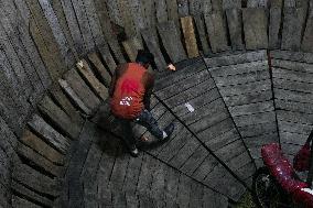 Two Circus Men Perform On The Wall Of Death