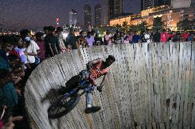 Two Circus Men Perform On The Wall Of Death