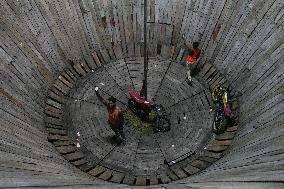 Two Circus Men Perform On The Wall Of Death