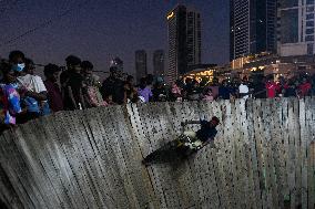 Two Circus Men Perform On The Wall Of Death