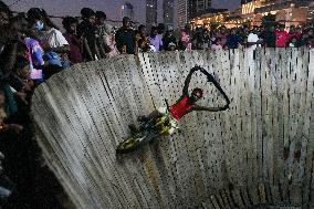 Two Circus Men Perform On The Wall Of Death