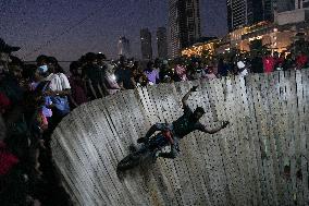 Two Circus Men Perform On The Wall Of Death