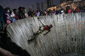 Two Circus Men Perform On The Wall Of Death