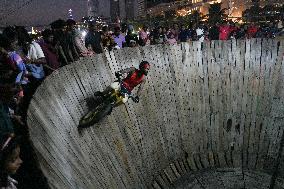 Two Circus Men Perform On The Wall Of Death