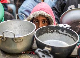 Palestinians Receive Food From A Charity Kitchen - Gaza