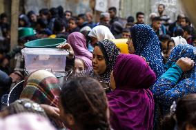 Palestinians Receive Food From A Charity Kitchen - Gaza