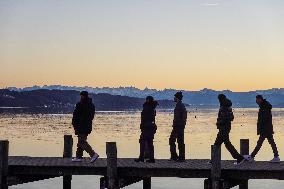 People Enjoying A Winter Evening At Lake Starnberg