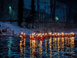 New Year's Torchlight Swim In The Bavarian River Lech In Fuessen