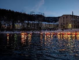 New Year's Torchlight Swim In The Bavarian River Lech In Fuessen