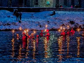 New Year's Torchlight Swim In The Bavarian River Lech In Fuessen