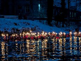 New Year's Torchlight Swim In The Bavarian River Lech In Fuessen