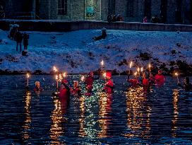 New Year's Torchlight Swim In The Bavarian River Lech In Fuessen