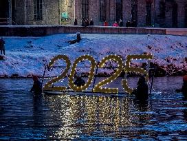 New Year's Torchlight Swim In The Bavarian River Lech In Fuessen