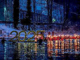 New Year's Torchlight Swim In The Bavarian River Lech In Fuessen