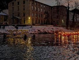 New Year's Torchlight Swim In The Bavarian River Lech In Fuessen