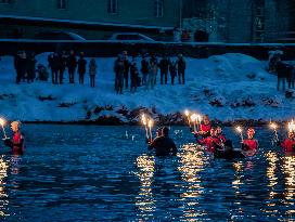 New Year's Torchlight Swim In The Bavarian River Lech In Fuessen